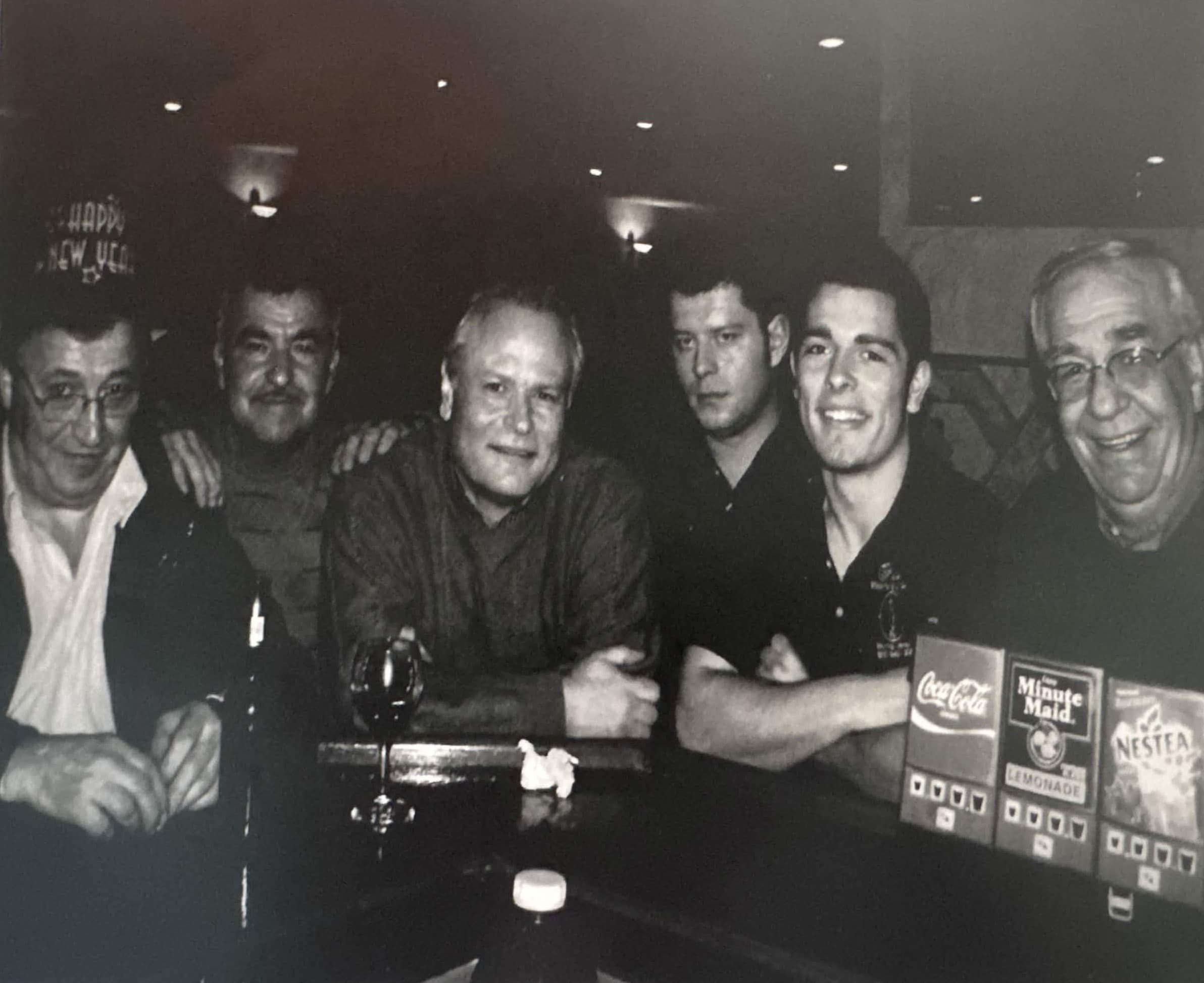 A group of six gathered around the Maria's bar.