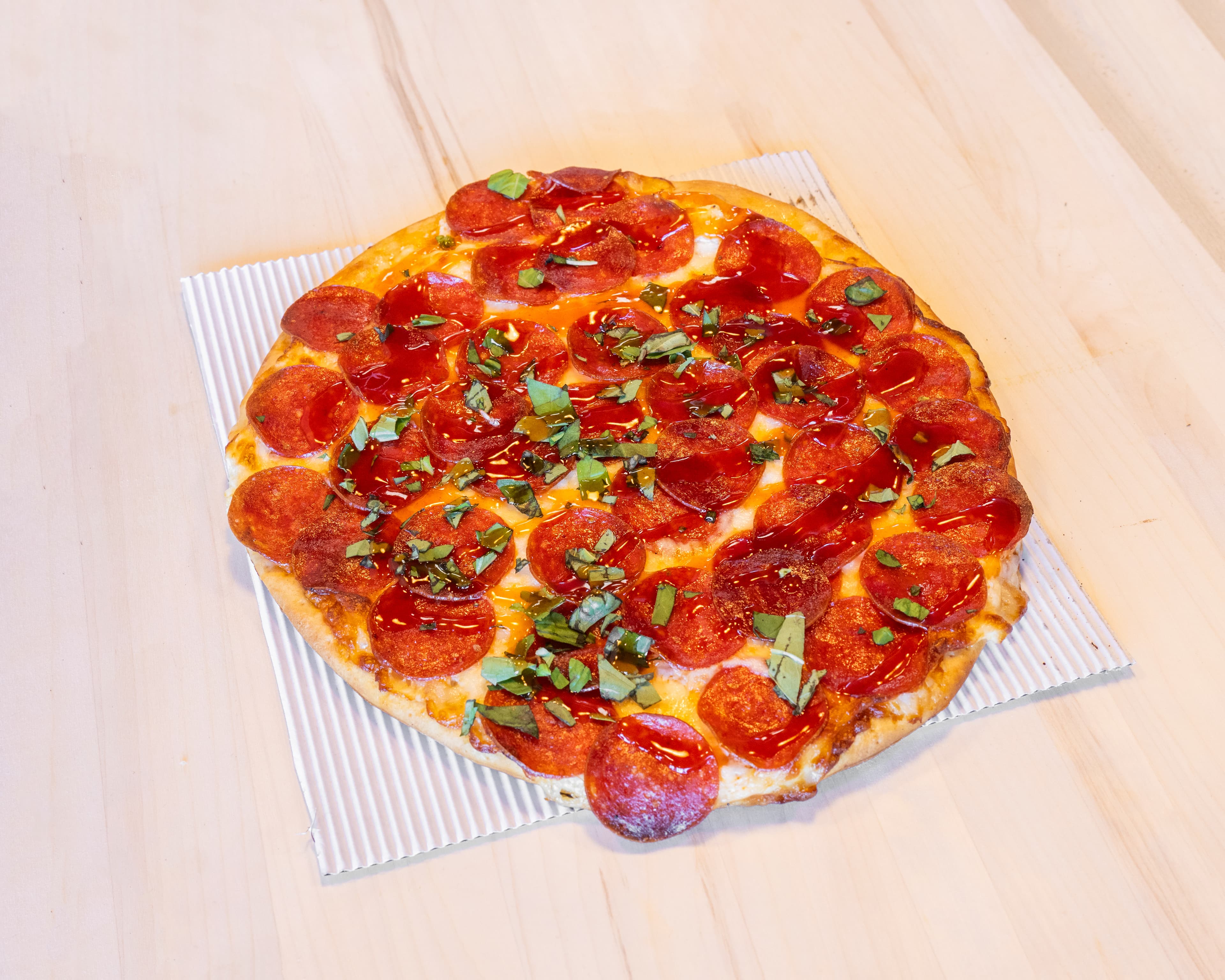 Hot honey pepperoni pizza with basil